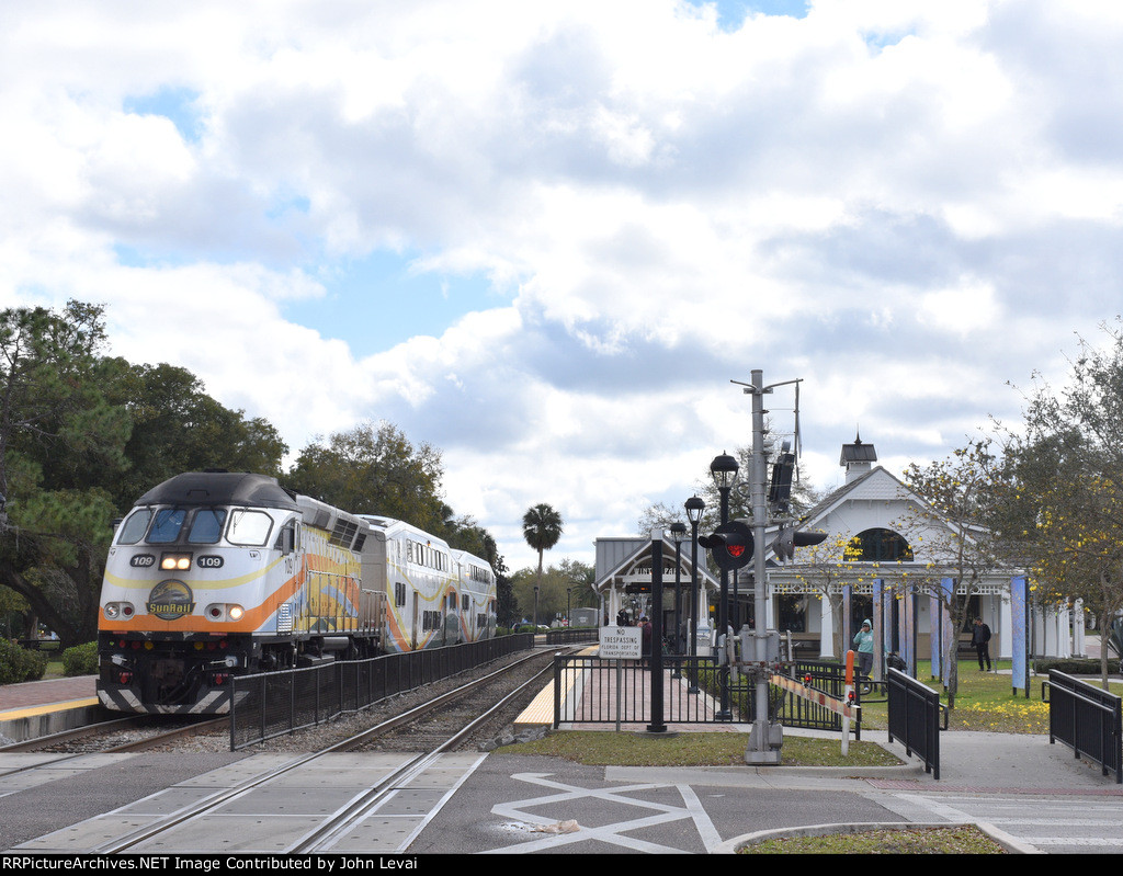 A DeLand bound Sunrail Train departs the magnificent Winter Park Station behind MP32PH-Q # 109.